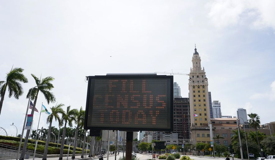 FILE - In this Oct. 5, 2020, file photo, a flashing sign near the iconic "Freedom Tower," advises people to fill out their census forms in downtown Miami. The Supreme Court’s decision to allow the Trump administration to end the 2020 census was another case of whiplash for the census, which has faced stops from the pandemic, natural disasters and court rulings. (AP Photo/Wilfredo Lee)