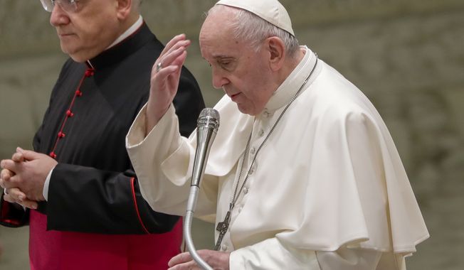 Pope Francis makes the sign of the cross at the start of his weekly general audience in the Pope Paul VI hall at the Vatican, Wednesday, Oct. 14, 2020. (AP Photo/Andrew Medichini)
