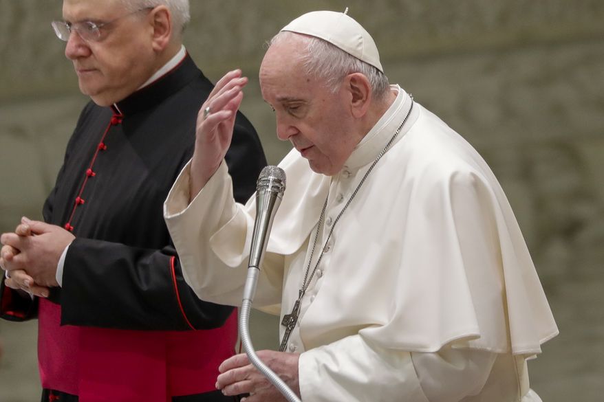 Pope Francis makes the sign of the cross at the start of his weekly general audience in the Pope Paul VI hall at the Vatican, Wednesday, Oct. 14, 2020. (AP Photo/Andrew Medichini)
