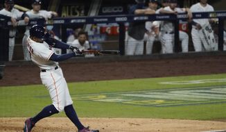 Houston Astros George Springer hits a two run home run against the Tampa Bay Rays during the fifth inning in Game 4 of a baseball American League Championship Series, Wednesday, Oct. 14, 2020, in San Diego. (AP Photo/Ashley Landis)