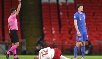 England&#39;s Harry Maguire, right, reacts as he is shown a red card by referee Jesus Gil Manzano, left, during the UEFA Nations League soccer match between England and Denmark at Wembley Stadium in London, England, Wednesday, Oct. 14, 2020. (Daniel Leal-Olivas/Pool via AP)