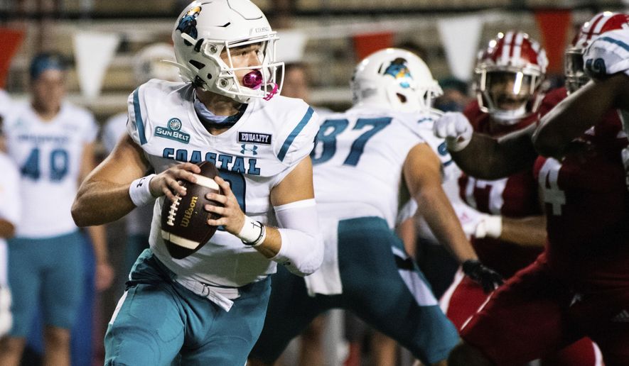 Coastal Carolina quarterback Grayson McCall (10) rolls out to attempt a pass during the first half of an NCAA football game against Louisiana-Lafayette in Lafayette, La., Wednesday, Oct. 14, 2020. (AP Photo/Paul Kieu)