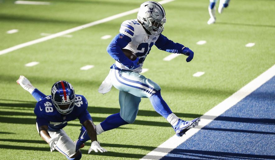Cowboys Ezekiel Elliott leaps out of the way to a touchdown during the game against New York Giants Sunday, Oct. 11, 2020, in Arlington, Texas. (Yffy Yossifor/Star-Telegram via AP)