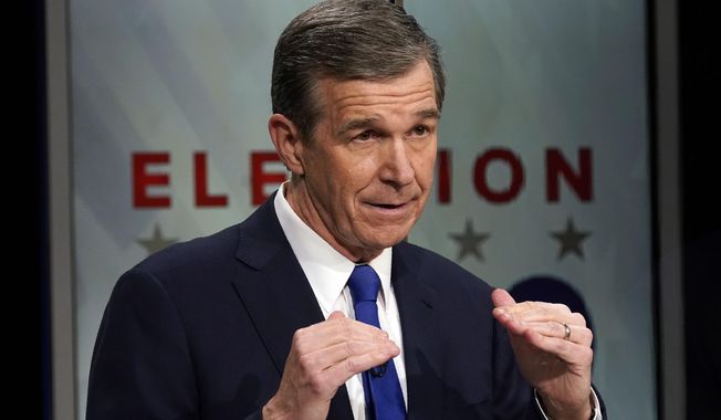 North Carolina Gov. Roy Cooper makes a comment during a live televised debate with Lt. Gov. Dan Forest at UNC-TV studios in Research Triangle Park, N.C., Wednesday, Oct. 14, 2020. (AP Photo/Gerry Broome)