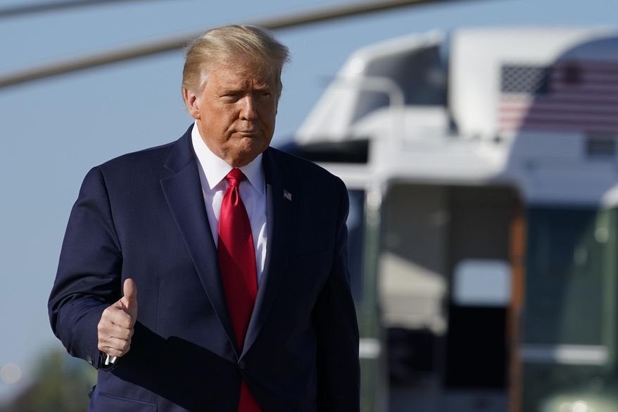 President Donald Trump gives a thumbs-up as he walks to board Air Force One, Wednesday, Oct. 14, 2020, at Andrews Air Force Base, Md. Trump is en route to Iowa. (AP Photo/Alex Brandon) **FILE**