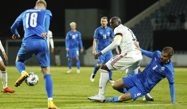Iceland&#x27;s Holmar Eyjolfsson, right, and Belgium&#x27;s Romelu Lukaku, centre, battle for the ball during the UEFA Nations League soccer match between Iceland and Belgium at the Laugardalsvollur stadium in Reykjavik, Iceland, Wednesday, Oct. 14, 2020. (AP Photo/Brynjar Gunnarsson)