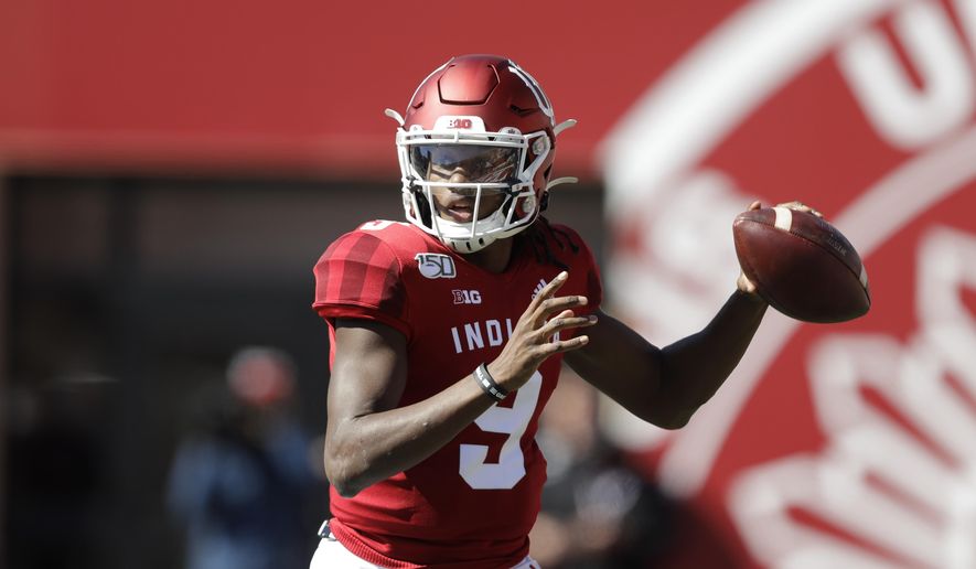 In this photo taken on Saturday, Oct. 12, 2019, Indiana quarterback Michael Penix Jr. (9) throws during the first half of an NCAA college football game against Rutgers, in Bloomington, Ind. The first two seasons for Indiana Hoosiers quarterback Michael Penix Jr. ended prematurely because of injuries. So the redshirt sophomore added 16 pounds to his 6-foot-3 frame in hopes of finishing his first full season. (AP Photo/Darron Cummings)