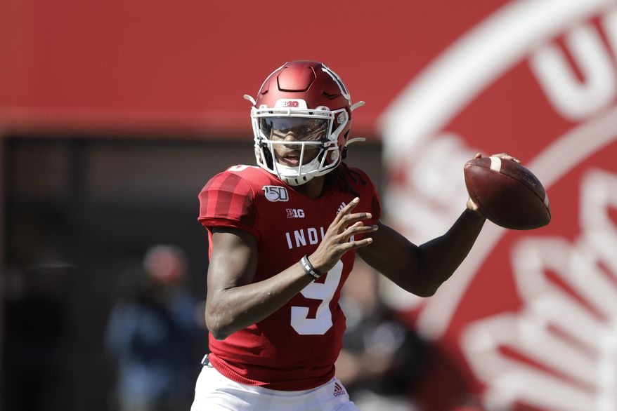 In this photo taken on Saturday, Oct. 12, 2019, Indiana quarterback Michael Penix Jr. (9) throws during the first half of an NCAA college football game against Rutgers, in Bloomington, Ind. The first two seasons for Indiana Hoosiers quarterback Michael Penix Jr. ended prematurely because of injuries. So the redshirt sophomore added 16 pounds to his 6-foot-3 frame in hopes of finishing his first full season. (AP Photo/Darron Cummings)