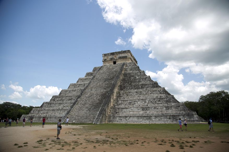 In this Aug. 3, 2018 file photo, tourists walk at the Mayan ruins of Chichen Itza in Mexico&#39;s Yucatan Peninsula. Experts in Mexico said Wednesday, Oct. 14, 2020, that they have detected more than 2,000 pre-Hispanic ruins or clusters of artefacts along the proposed route of the president&#39;s controversial “Maya Train” project on the Yucatan peninsula, which could slow down the already disputed project. (AP Photo/Eduardo Verdugo) **FILE**