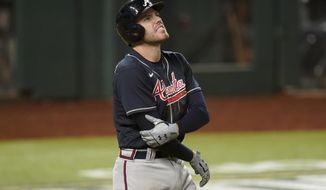 Atlanta Braves&#x27; Freddie Freeman holds his arm after getting hit by a pitch against the Los Angeles Dodgers during the eighth inning in Game 2 of a baseball National League Championship Series Tuesday, Oct. 13, 2020, in Arlington, Texas. (AP Photo/Eric Gay)