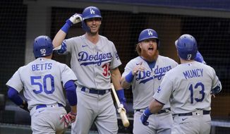 Los Angeles Dodgers&#x27; Max Muncy (13) celebrates his grand slam home run during the first inning in Game 3 of a baseball National League Championship Series against the Atlanta Braves Wednesday, Oct. 14, 2020, in Arlington, Texas. (AP Photo/Tony Gutierrez)
