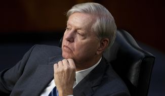 Sen. Lindsey Graham, R-S.C., listens during a confirmation hearing for Supreme Court nominee Amy Coney Barrett before the Senate Judiciary Committee, Wednesday, Oct. 14, 2020, on Capitol Hill in Washington. (Michael Reynolds/Pool via AP)