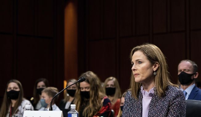 Supreme Court nominee Amy Coney Barrett listens during a confirmation hearing before the Senate Judiciary Committee, Wednesday, Oct. 14, 2020, on Capitol Hill in Washington. (Erin Schaff/The New York Times via AP, Pool)