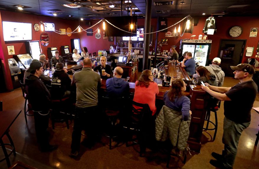 FILE - In this May 13, 2020 file photo, The Dairyland Brew Pub opens to patrons in Appleton, Wis. A Wisconsin judge on Wednesday, Oct. 14, temporarily blocked an order from Gov. Tony Evers' administration limiting the number of people who can gather in bars, restaurants and other indoor places. (William Glasheen/The Post-Crescent via AP File)