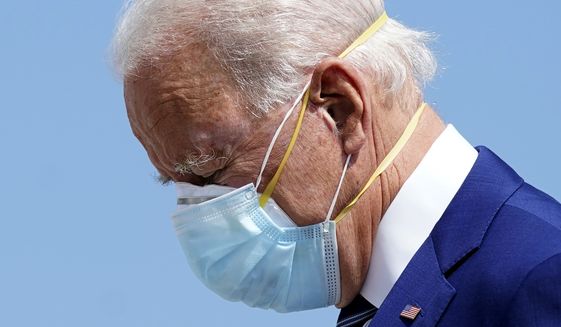 Democratic presidential candidate former Vice President Joe Biden wears two face masks as he arrives at Fort Lauderdale-Hollywood International Airport, in Fort Lauderdale, Fla., Tuesday Oct. 13, 2020. (AP Photo/Carolyn Kaster)
