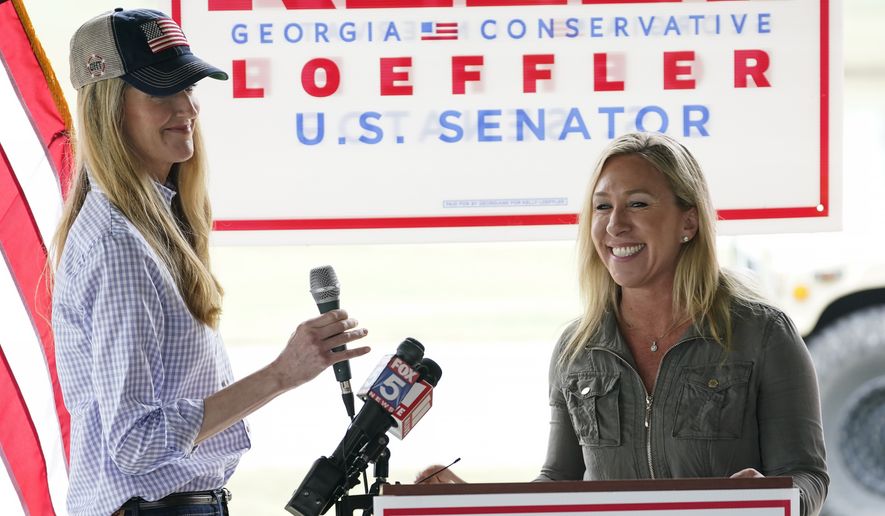Marjorie Taylor Greene, right, introduces Sen. Kelly Loeffler, R-Ga., left, during a news conference on Thursday, Oct. 15, 2020, in Dallas, Ga. (AP Photo/Brynn Anderson)