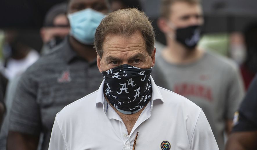 In this Aug. 31, 2020, file photo, Alabama head football coach Nick Saban leads his team as they march on campus, supporting the Black Lives Matter movement, in Tuscaloosa, Ala. The mid-week news that Alabama coach Nick Saban tested positive for COVID-19 added a challenging backdrop for the season’s first Top 5 matchup. Saban figures to be communicating his marching orders and input from home while offensive coordinator Steve Sarkisian is manning the show within the football building. (AP Photo/Vasha Hunt, File)  **FILE**