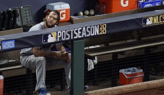 Los Angeles Dodgers starting pitcher Clayton Kershaw sits in the dugout after leaving the game during the sixth inning in Game 4 of a baseball National League Championship Series against the Atlanta Braves Thursday, Oct. 15, 2020, in Arlington, Texas. (AP Photo/Sue Ogrocki)  **FILE**