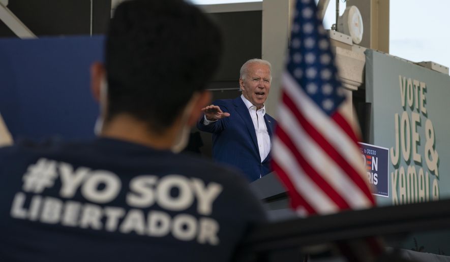 Democratic presidential candidate former Vice President Joe Biden speaks at Miramar Regional Park in Miramar, Fla., Tuesday Oct. 13, 2020, as supporters watch from their cars. (AP Photo/Carolyn Kaster)