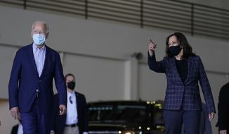 In this Oct. 8, 2020, photo, Democratic presidential candidate former Vice President Joe Biden and vice presidential candidate Sen. Kamala Harris, D-Calif., walk in a hanger before leaving Phoenix Sky Harbor International Airport, in Phoenix. Biden’s presidential campaign says Harris will suspend in-person events until Oct. 19, after two people associated with the campaign tested positive for coronavirus. (AP Photo/Carolyn Kaster)