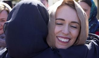 FILE - In this Sept. 24, 2020, file photo, New Zealand Prime Minister Jacinda Ardern is embraced as she arrives at the Al Noor mosque in Christchurch, New Zealand. Opinion polls indicate Ardern is on track to win a second term as prime minister in an election on Saturday, Oct. 17, 2020. (AP Photo/Mark Baker) (AP Photo/Mark Baker)