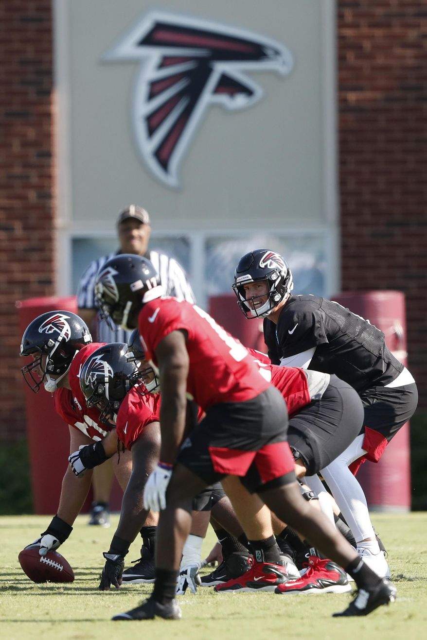 In this July 25, 2019, file photo, Atlanta Falcons quarterback Matt Ryan (2) and the offense prepare to run a play during their NFL training camp football practice in Flowery Branch, Ga. The Atlanta Falcons shut their facility Thursday, Oct. 15, 2020, following one new positive test for COVID-19. The team remains scheduled to play at Minnesota on Sunday. (AP Photo/John Bazemore, File)  **FILE**