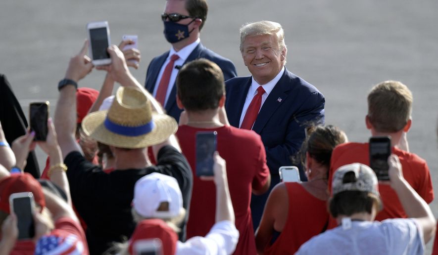 President Donald Trump acknowledges supporters after arriving for a campaign rally at the Ocala International Airport, Friday, Oct. 16, 2020, in Ocala, Fla. (AP Photo/Phelan M. Ebenhack)