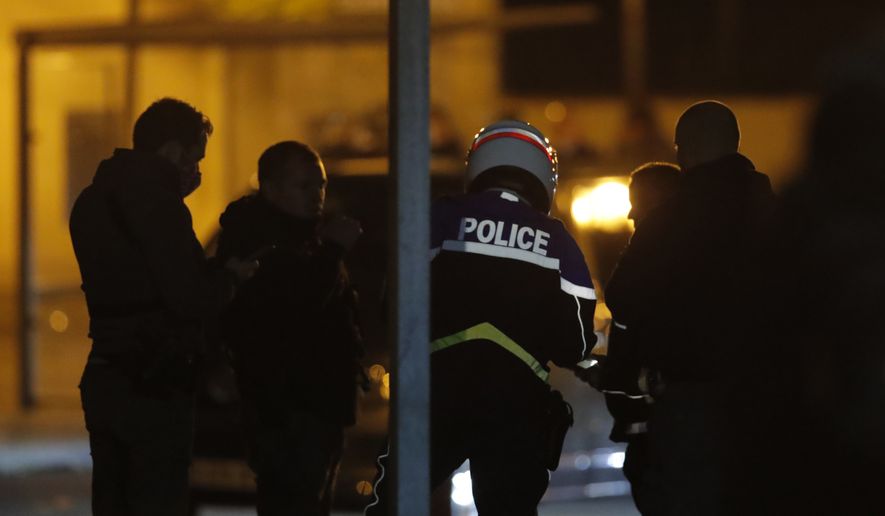 French police officers gather outside a high school after a history teacher who opened a discussion with students on caricatures of Islam&#39;s Prophet Muhammad was beheaded, Friday, Oct. 16, 2020 in Conflans-Saint-Honorine, north of Paris. Police have shot the suspected killer dead. (AP Photo/Michel Euler)