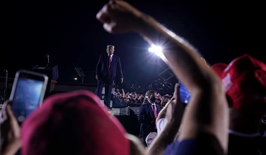 Supporters cheer as President Donald Trump leaves after speaking at a campaign rally at Middle Georgia Regional Airport, Friday, Oct. 16, 2020, in Macon, Ga. (AP Photo/Evan Vucci)