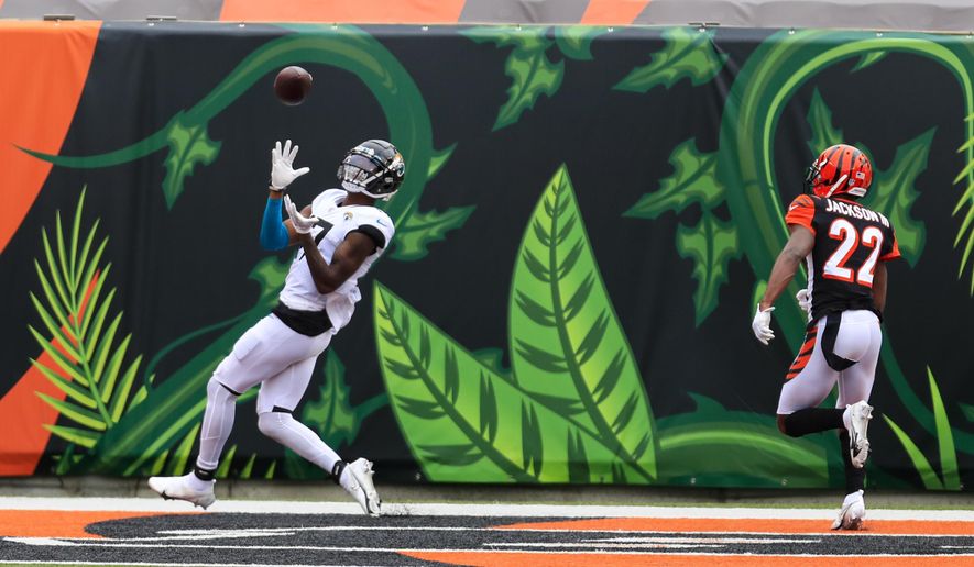 Jacksonville Jaguars wide receiver D.J. Chark (17) makes a catch for a touchdown in front of Cincinnati Bengals cornerback William Jackson (22) in the first half of an NFL football game in Cincinnati, Sunday, Oct. 4, 2020. (AP Photo/Aaron Doster)