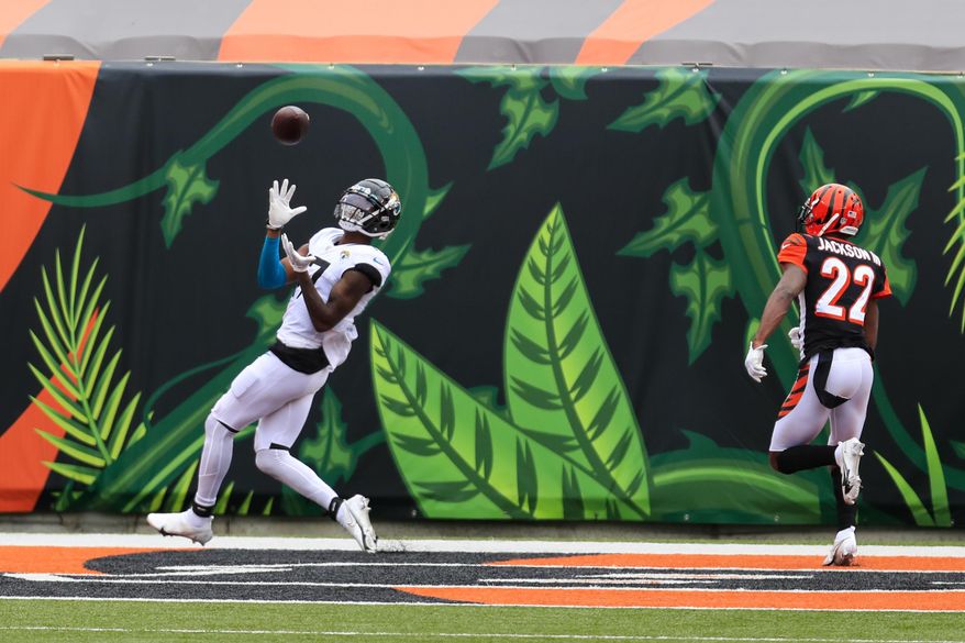 Jacksonville Jaguars wide receiver D.J. Chark (17) makes a catch for a touchdown in front of Cincinnati Bengals cornerback William Jackson (22) in the first half of an NFL football game in Cincinnati, Sunday, Oct. 4, 2020. (AP Photo/Aaron Doster)