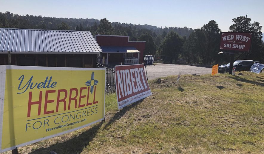 A campaign sign for Republican U.S. House hopeful Yvette Herrell sits in front of the Wild West Ski Shop in Ruidoso, N.M., on Oct. 6, 2020. New Mexico is on the verge of electing the nation&#39;s largest all-female of color U.S. House delegation but the close race in the state&#39;s southern district, where Ruidoso sits, is grabbing the most attention. (AP Photo/ Russell Contreras)