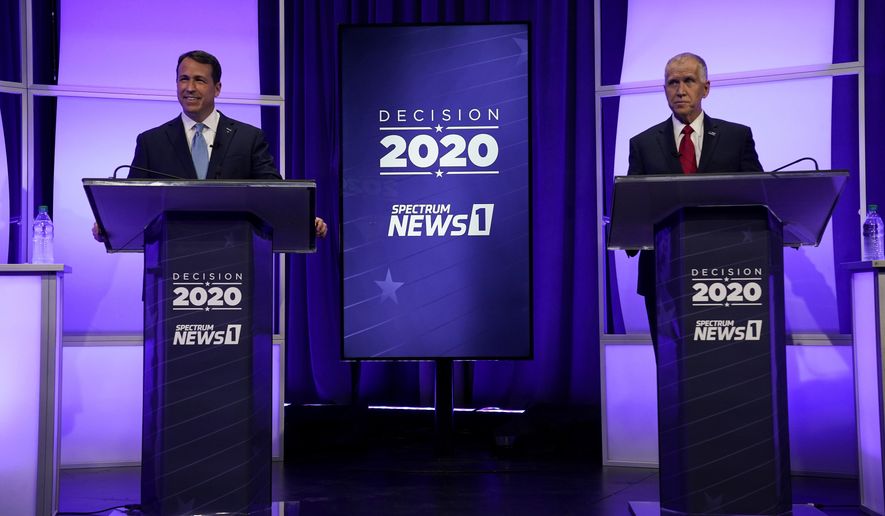 Democratic challenger Cal Cunningham, left, and U.S. Sen. Thom Tillis, R-N.C. wait for the start of a televised debate Thursday, Oct. 1, 2020 in Raleigh, N.C. (AP Photo/Gerry Broome, Pool)