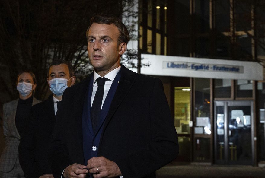 French President Emmanuel Macron, flanked by French Interior Minister Gerald Darmanin, second left, speaks in front of a high school Friday Oct.16, 2020 in Conflans Sainte-Honorine, northwest of Paris, after a history teacher who opened a discussion with high school students on caricatures of Islam&#39;s Prophet Muhammad was beheaded. French President Emmanuel Macron denounced what he called an &amp;quot;Islamist terrorist attack&amp;quot; against a history teacher decapitated in a Paris suburb Friday, urging the nation to stand united against extremism. (Abdulmonam Eassa, Pool via AP)