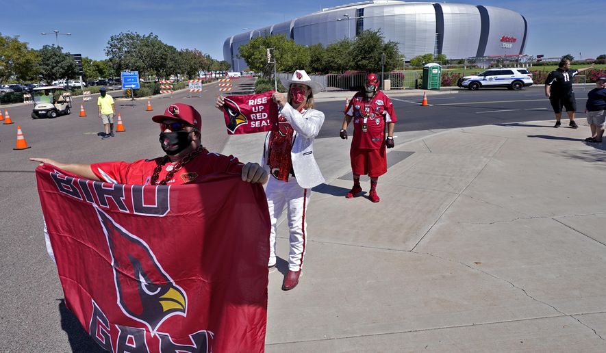 Arizona Cardinals fans cheer outside State Farm Stadium as teams arrive prior to an NFL football game against the Detroit Lions, Sunday, Sept. 27, 2020, in Glendale, Ariz. (AP Photo/Ross D. Franklin)