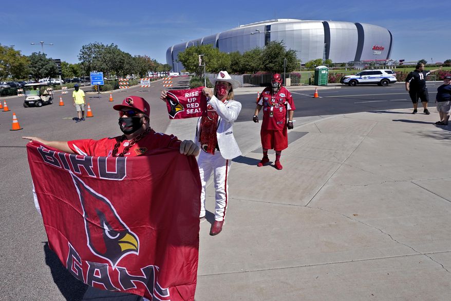 Arizona Cardinals fans cheer outside State Farm Stadium as teams arrive prior to an NFL football game against the Detroit Lions, Sunday, Sept. 27, 2020, in Glendale, Ariz. (AP Photo/Ross D. Franklin)