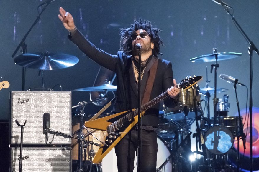 FILE - Lenny Kravitz performs at the 2017 Rock and Roll Hall of Fame induction ceremony in New York on April 7, 2017. In a new memoir, "Let Love Rule," Kravitz explores his childhood and ends with him on the verge of stardom and deeply in love with actress Lisa Bonet. (Photo by Charles Sykes/Invision/AP, File)