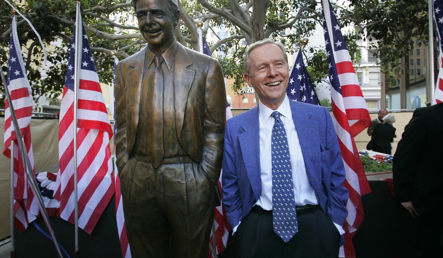 FILE - In this Aug. 25, 2007, file photo, former California Gov. Pete Wilson imitates the pose of a statue dedicated in his honor at Horton Plaza in San Diego. The statue was removed from the park after critics said the governor supported laws and policies that hurt immigrants and LGBTQ community members, the San Diego Union-Tribune reported Thursday, Oct. 16, 2020.  (Nelvin Cepeda/The San Diego Union-Tribune via AP)
