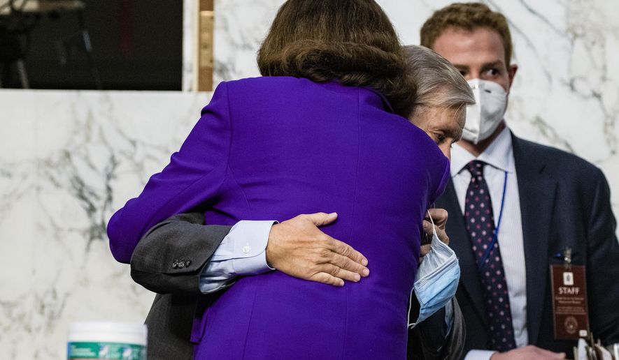 Sen. Lindsey Graham, R-S.C., hugs Sen. Dianne Feinstein, D-Calif., at the close of the confirmation hearing for Supreme Court nominee Amy Coney Barrett, before the Senate Judiciary Committee, Thursday, Oct. 15, 2020, on Capitol Hill in Washington. (Samuel Corum/Pool via AP)