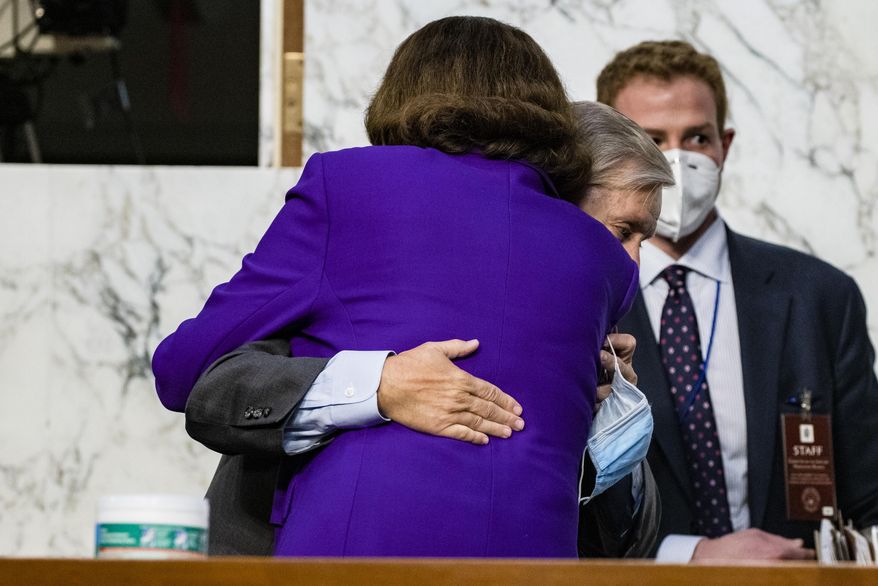 Sen. Lindsey Graham, R-S.C., hugs Sen. Dianne Feinstein, D-Calif., at the close of the confirmation hearing for Supreme Court nominee Amy Coney Barrett, before the Senate Judiciary Committee, Thursday, Oct. 15, 2020, on Capitol Hill in Washington. (Samuel Corum/Pool via AP)