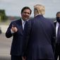 In this file photo, President Donald Trump speaks with Florida Gov. Ron DeSantis as he arrives at Southwest Florida International Airport, Friday, Oct. 16, 2020, in Fort Myers, Fla. (AP Photo/Evan Vucci)