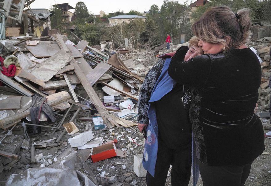 A neighbour comforts home owner, Lida Sarksyan, left, near her house destroyed by shelling from Azerbaijan&#x27;s artillery during a military conflict in Stepanakert, the separatist region of Nagorno-Karabakh, Saturday, Oct. 17, 2020. The latest outburst of fighting between Azerbaijani and Armenian forces began Sept. 27 and marked the biggest escalation of the decades-old conflict over Nagorno-Karabakh. The region lies in Azerbaijan but has been under control of ethnic Armenian forces backed by Armenia since the end of a separatist war in 1994. (AP Photo)