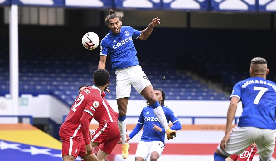 Everton&#39;s Dominic Calvert-Lewin, top, scores his side&#39;s second goal to make the score 2-2 during the English Premier League soccer match between Everton and Liverpool at Goodison Park stadium, in Liverpool, England, Saturday, Oct. 17, 2020. (Laurence Griffiths/Pool via AP)