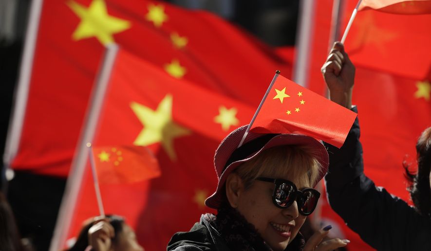 FILE - In this Dec. 7, 2019, file photo, pro-Beijing supporters wave Chinese national flags during a rally in Hong Kong. The Standing Committee of China&#39;s congress has passed amendments to a law that will criminalize the intentional insulting of the national flag and emblem, after anti-government protesters last year desecrated the Chinese flag. (AP Photo/Mark Schiefelbein, File)