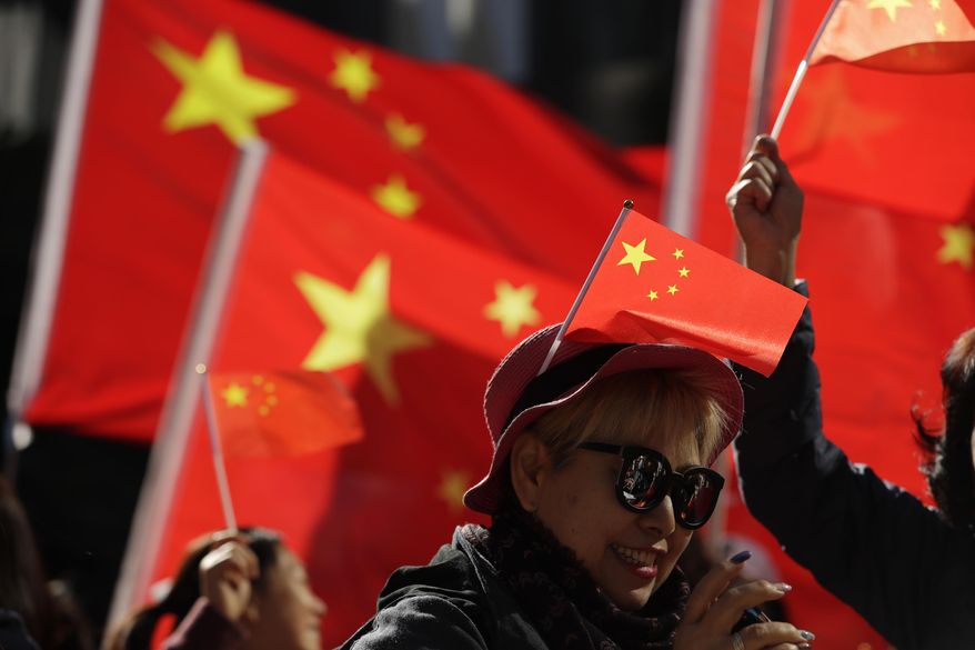 FILE - In this Dec. 7, 2019, file photo, pro-Beijing supporters wave Chinese national flags during a rally in Hong Kong. The Standing Committee of China's congress has passed amendments to a law that will criminalize the intentional insulting of the national flag and emblem, after anti-government protesters last year desecrated the Chinese flag. (AP Photo/Mark Schiefelbein, File)