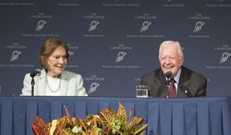 FILE - In this Sept. 17, 2019 file photo, former President Jimmy Carter and Rosalynn Carter talk about the future of The Carter Center and their global work during a town hall in Atlanta.  As the country barrels toward one of the most contentious elections in American history, already dripping with tension about the whole voting process, the Atlanta-based Carter Center is taking the unprecedented step to get involved in U.S. elections. (Branden Camp/Atlanta Journal-Constitution via AP)