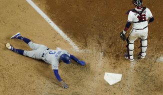 Los Angeles Dodgers&#39; Chris Taylor scores past Atlanta Braves catcher Travis d&#39;Arnaud on a hit by Mookie Betts during the seventh inning in Game 5 of a baseball National League Championship Series Friday, Oct. 16, 2020, in Arlington, Texas. (AP Photo/David J. Phillip)