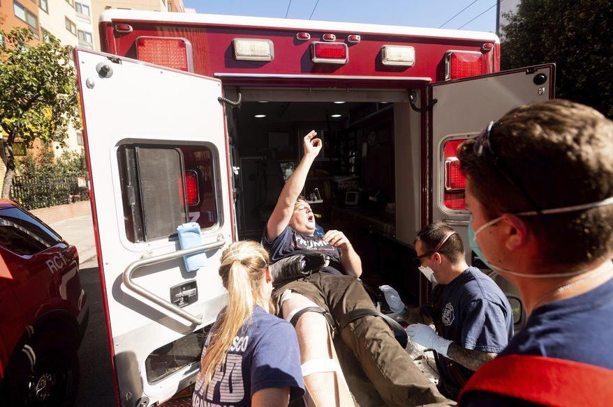 Medics transport a supporter of President Donald Trump to an ambulance after he was attacked by counter-protesters in San Francisco on Saturday, Oct. 17, 2020. About a dozen pro-Trump demonstrators were met by several hundred counter-protesters as they tried to rally. (AP Photo/Noah Berger)