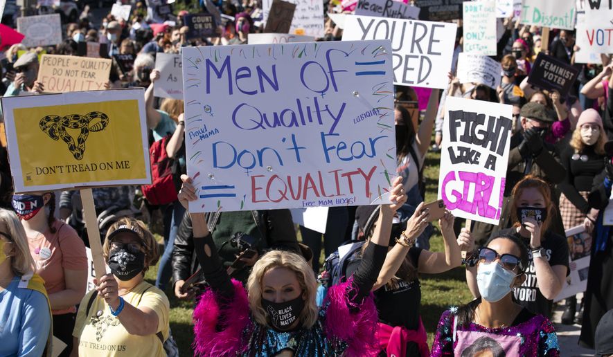 Protestors rally during the Women&#39;s March at Freedom Plaza, Saturday, Oct. 17, 2020, in Washington. (AP Photo/Jose Luis Magana)