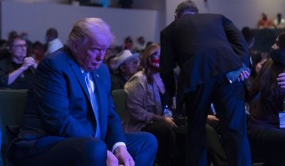 President Donald Trump prepares his offering as he attends church at International Church of Las Vegas, Sunday, Oct. 18, 2020, in Las Vegas, Nev. (AP Photo/Alex Brandon)